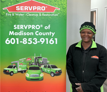 Mary - female employee next to SERVPRO sign